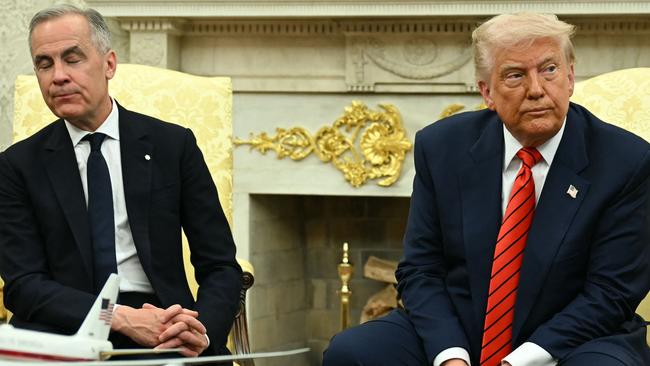 US President Donald Trump and Canadian Prime Minister Mark Carney look on as they meet in the Oval Office of the White House in Washington, DC, on May 6, 2025. (Photo by Jim WATSON / AFP)