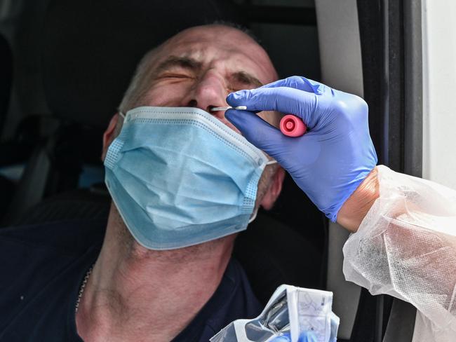 A medical staff member collect samples from Frederic, aged 44, to be tested for the novel coronavirus COVID-19 as he lost the sense of smell and taste, at the Dyomedea-Neolab drive laboratory on April 22, 2020 in Villefranche-sur-Saône near Lyon , southeastern France, on the 37th day of a strict lockdown in France to stop the spread of the virus. (Photo by PHILIPPE DESMAZES / AFP)