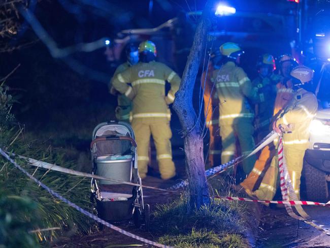 Emergency crews at the scene of the fatal crash near the Upwey station. Picture: Tony Gough