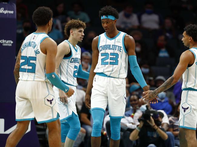 CHARLOTTE, NORTH CAROLINA - OCTOBER 07: Kai Jones #23 of the Charlotte Hornets reacts with his teammates P.J. Washington #25, LaMelo Ball #2, and James Bouknight #5 during the third period of their game against the Memphis Grizzlies at Spectrum Center on October 07, 2021 in Charlotte, North Carolina. NOTE TO USER: User expressly acknowledges and agrees that, by downloading and or using this photograph, User is consenting to the terms and conditions of the Getty Images License Agreement.   Jared C. Tilton/Getty Images/AFP == FOR NEWSPAPERS, INTERNET, TELCOS & TELEVISION USE ONLY ==