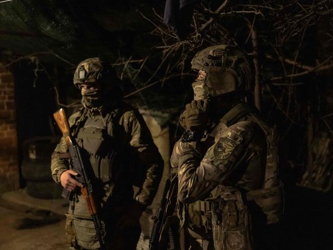 Ukrainian soldiers from the 5th Assault Brigade gather before heading for a 4-day rotation to the frontline, in an undisclosed area near the town of Chasiv Yar, Donetsk region, on March 28, 2024, amid the Russian invasion of Ukraine. The eastern city of Chasiv Yar is facing a "difficult and tense" situation, a Ukrainian army official said on March 25, 2024. If Russia took Chasiv Yar, it could step up attacks on the strategic city of Kramatorsk that is already facing growing bombardment. (Photo by Roman PILIPEY / AFP)