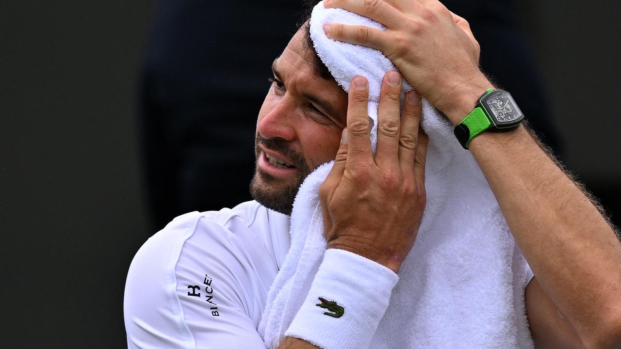 Bulgaria's Grigor Dimitrov towels off on July 1, 2024. (Photo by ANDREJ ISAKOVIC / AFP) / RESTRICTED TO EDITORIAL USE