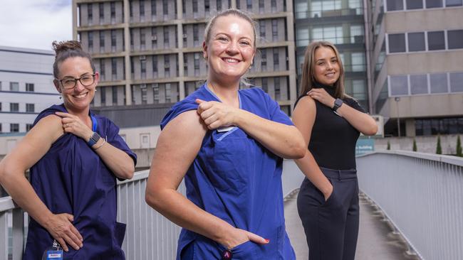 Nurses at the Austin rolling up their sleeves in support of the COVID vaccine.