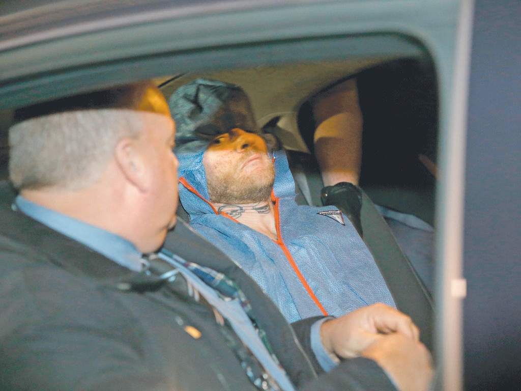 Steven Peet being escorted from the Lyle McEwin Emergency Department by SA detectives on the day the bodies were discovered. Picture: Emma Brasier