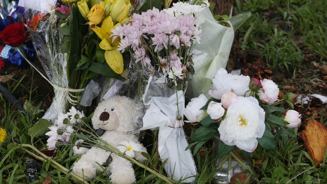 Floral tributes at the scene of fatal crash among broken car pieces and tree bark at the scene of a fatal traffic crash at Manoora. Passenger Bradley Smith, 14, was declared dead at the scene, and five other children aged 12 to 15 were taken to Cairns Hospital with injuries. Picture: Brendan Radke