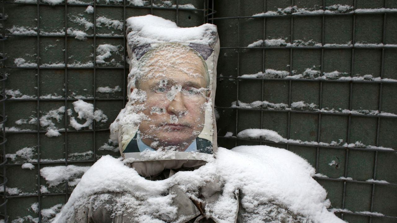 A poster of Russian President Vladimir Putin is used as target practice along a trench on the frontline with Russia-backed separatists near Zolote village, in the Lugansk region. Picture: Anatolii STEPANOV / AFP.