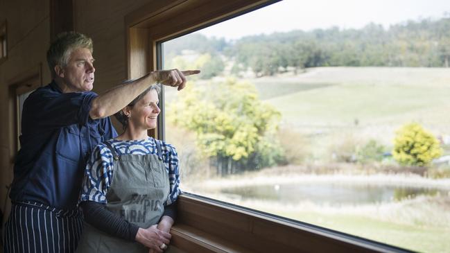 Fat Pig Farm's Matthew Evans and Sadie Chrestman admire the view at their Cygnet property. Picture: Alan Benson