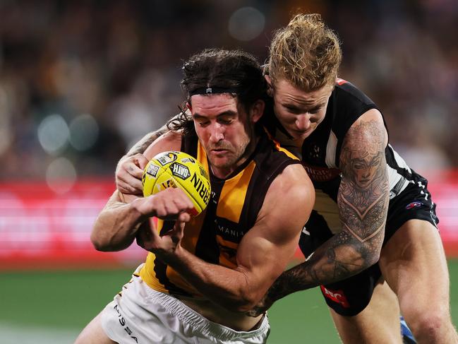 Jai Newcombe is tackled by Beau McCreery during the Hawks’ fightback in the second half. Picture: James Elsby/Getty Images.