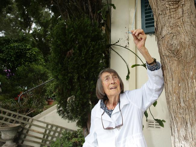 Gwyneth Crawford with the cut strings left behind after trespassers stole her two pro-refugee banners which had been displayed against her Mosman house. Picture: Annika Enderborg