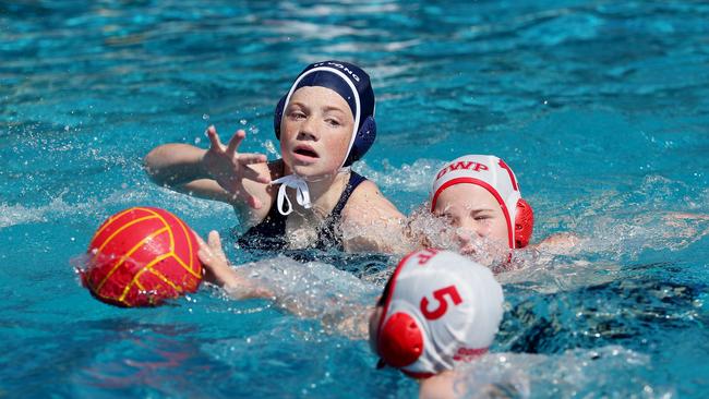 Wyong’s Mia Akhurst up against Gosford’s Aidan Tennant and Zachariah Diamond-Hanham in their under-12 mixed clash at Gosford Pool on Saturday. Picture: Sue Graham