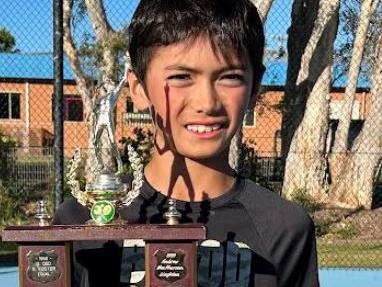 Joshua Burns with the spoils after winning three titles at the NSW Closed Country Championship Junior event at Forster.