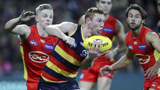 28/04/18 - AFL - Round 6 - Adelaide Crows v Gold Coast Suns at the Adelaide Oval. Tom Lynch gets his handpass out from Max Spencer. Picture SARAH REED