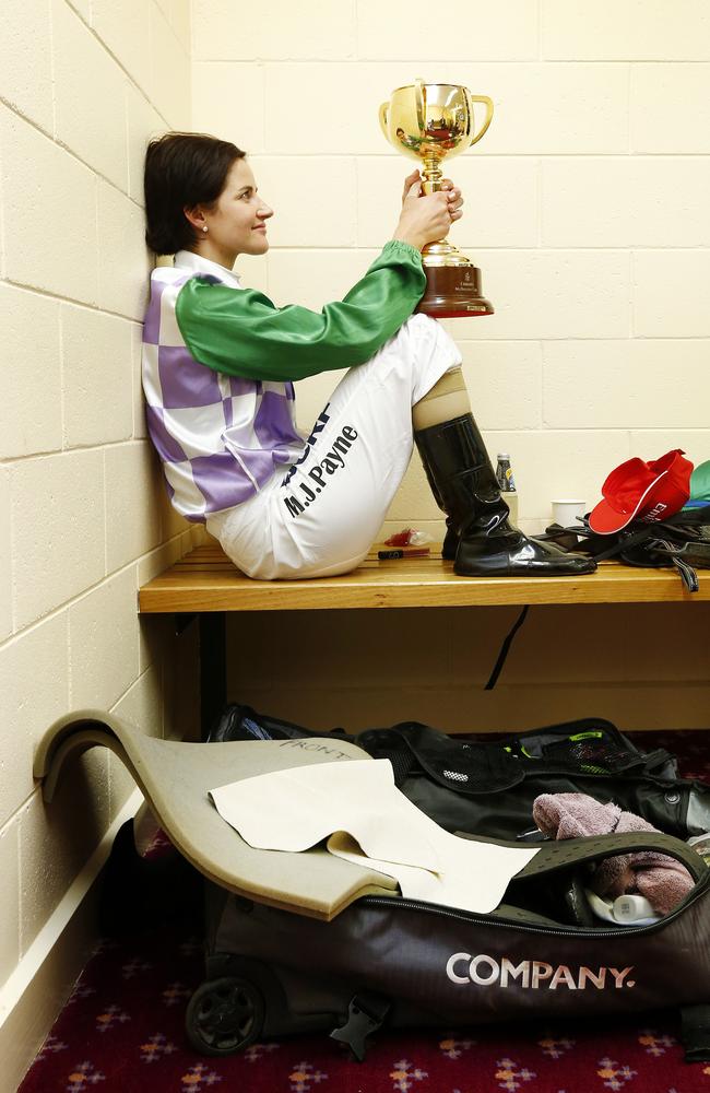 Michelle Payne spends a quiet moment in the jockeys room with the Melbourne Cup. Picture: Colleen Petch