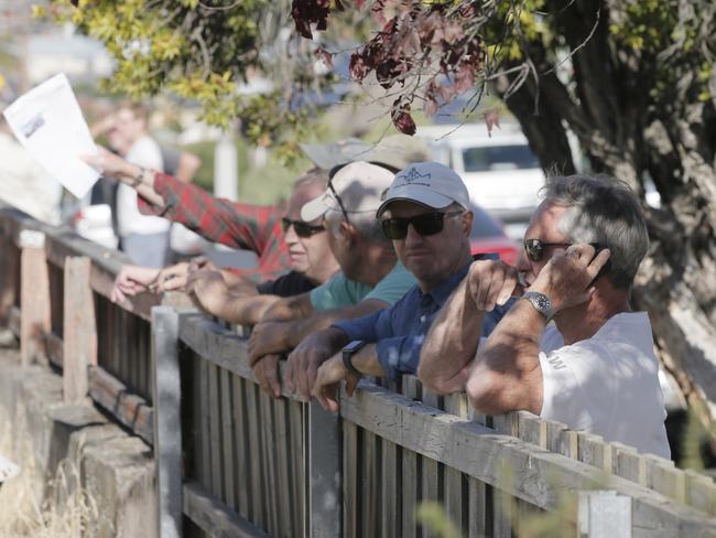 Angry neighbours look on as the house is demolished.