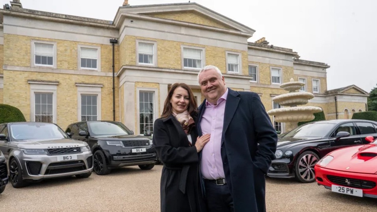 Peter Waddell, 58, with his wife Gabby and some of their cars pictured outside their home. Picture: John McLellan / The Sun