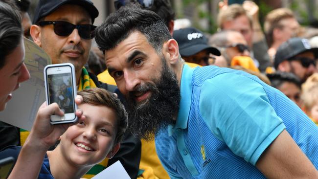 Mile Jedinak poses for photos with fans at Martin Place in Sydney. Picture: AFP