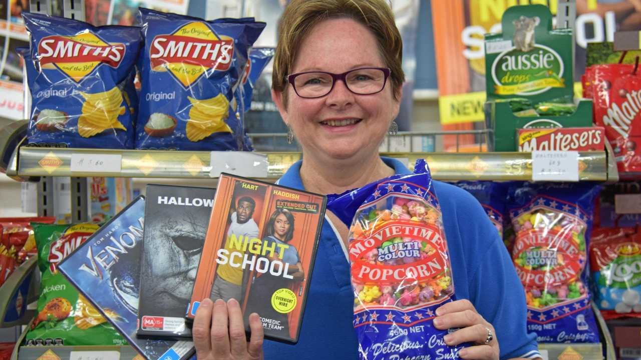 NOT GOING ANYWHERE: Cathy Ward from Top Video, Murgon, with some new release movies and the family favourite, popcorn. Picture: Matt Collins