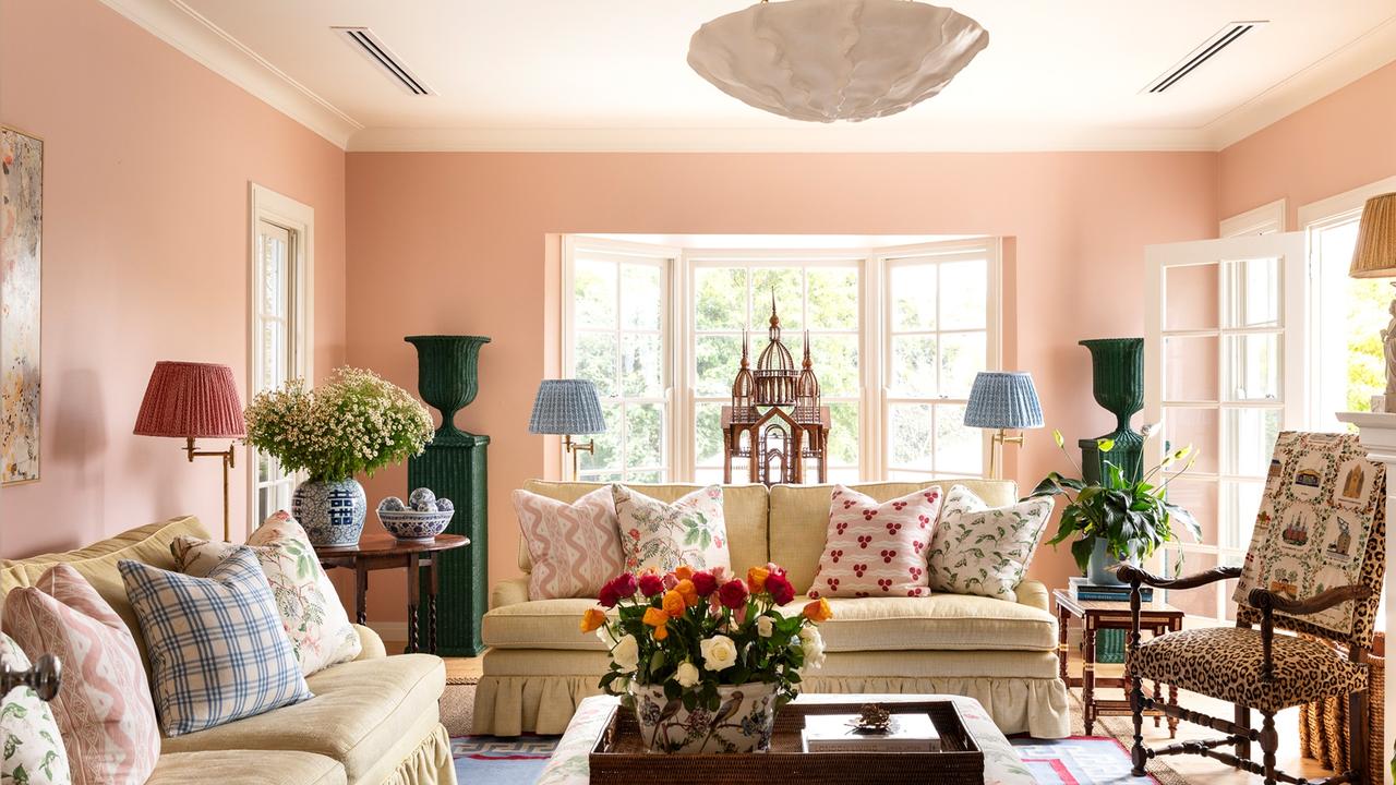 The sitting room with pink-painted walls is a favourite place for the family to spend time together.