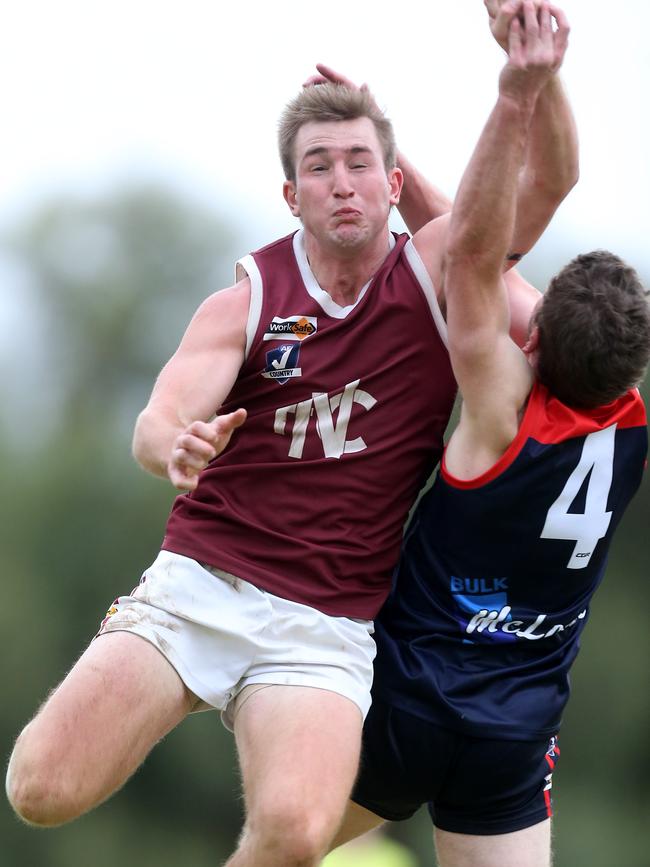 Nullawil’s Jordan Humphreys punches the ball clear of Wycheproof-Narraport’s Justin Bateson on Saturday.