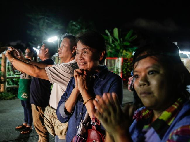 Onlookers watch and cheer as ambulances deliver boys rescued from a cave in northern Thailand to hospital in Chiang Rai. Picture: Getty