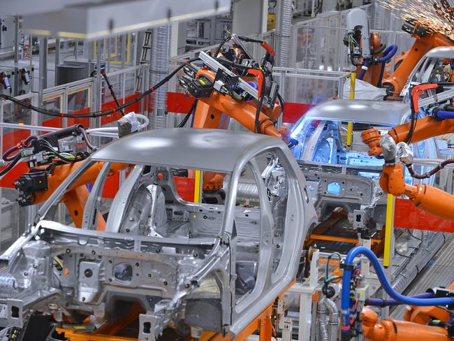 robots welding in an automobile factory