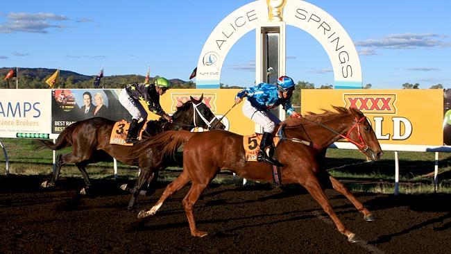 Justin Potter aboard Pretty Blonde wins the Alice Springs cup from Chieftain Jack. Pictur