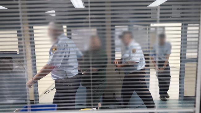 Prison officers escort a prisoner in the block. Picture: News Corp