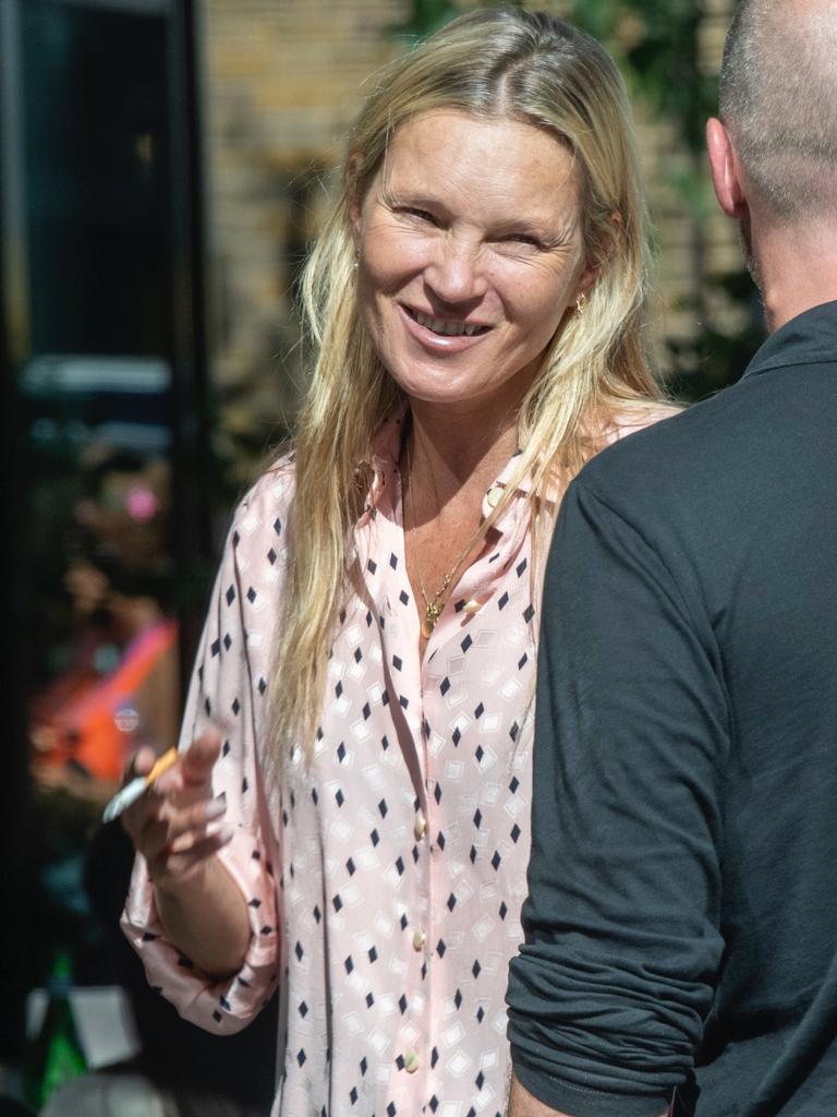 Kate Moss looks unrecognisable while smoking a cigarette during family