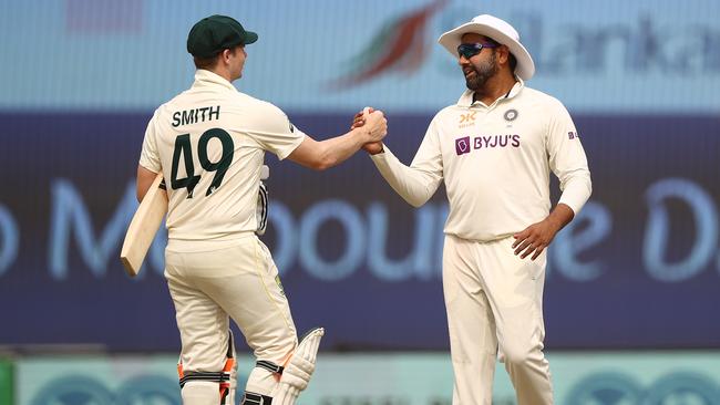 Steve Smith shakes hands with India’s Rohit Sharma to mercifully end the dull fourth Test. Picture: Getty