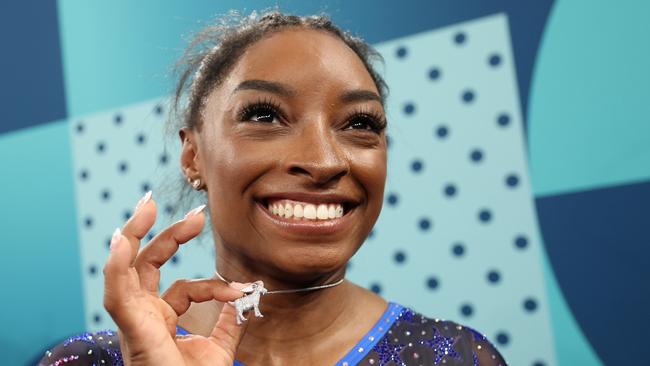 Simone Biles shows off her GOAT necklace. Picture: Getty Images