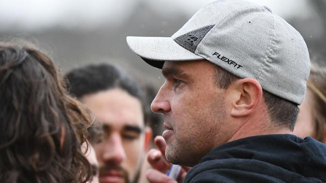 Ivanhoe coach Leigh Cole addresses his team, which won its first game of the season on Saturday.