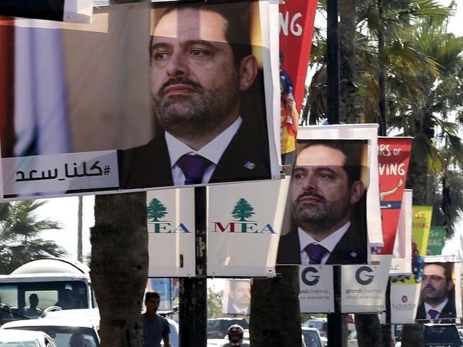 Posters of former Lebanese Prime Minister Saad Hariri hang in Beirut with a caption reading below in Arabic ‘We are all Saad’. Picture: AFP