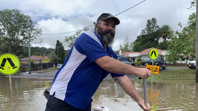 Fowler Street resident Max Walker paddles past his flood filled home on March 1, 2022. Picture: Stuart Cumming