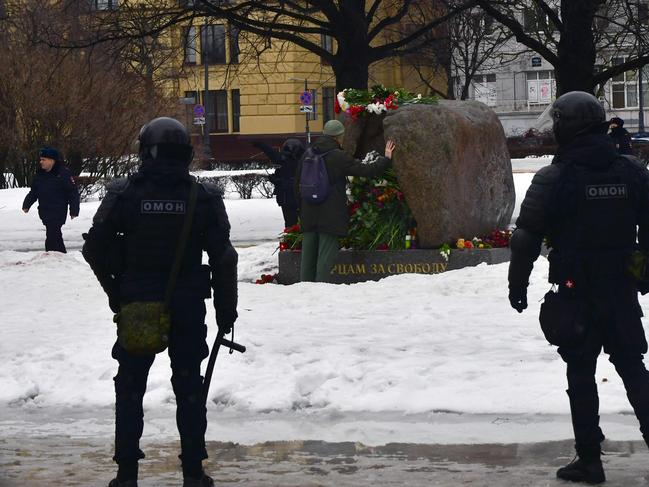 Riot police officers are seen deployed at the monument to the victims of political repressions as people come to it to lay flowers for Alexei Navalny in St Petersburg. Picture: AFP
