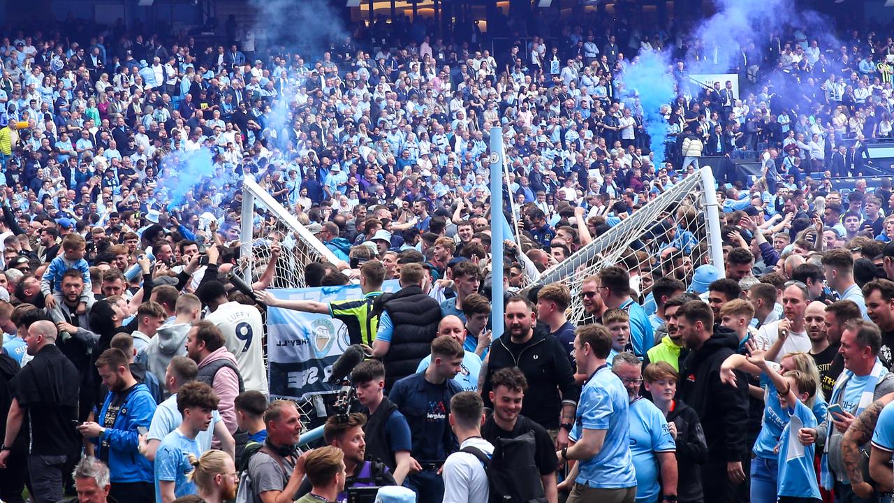 Fans of Manchester City celebrate winning the Premier League. Photo by Robbie Jay Barratt – AMA/Getty Images