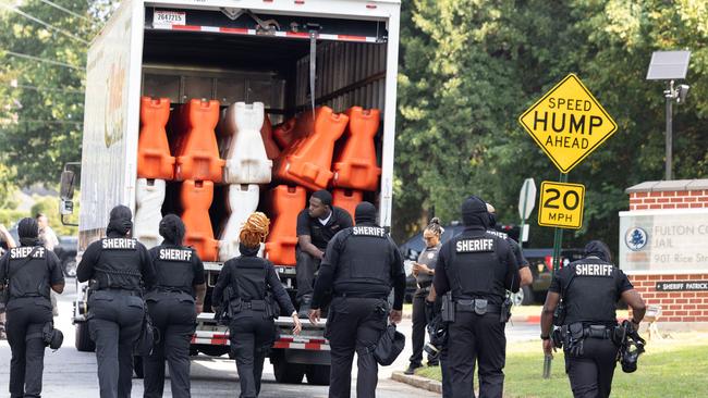 Fulton County Sheriff's Deputies place barricades outside of the Fulton County Jail ahead of former President Donald Trump's surrender. Picture: Getty Images via AFP.