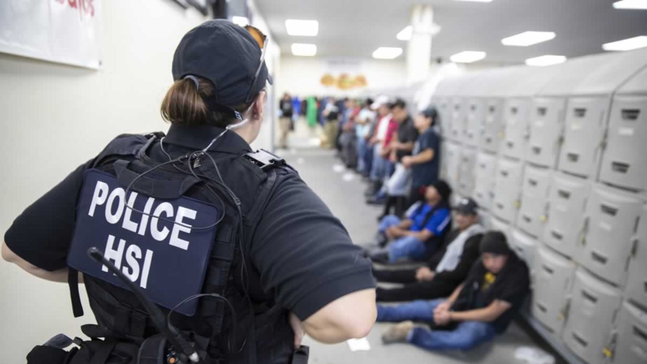 A Homeland Security Investigations (HSI) officer guards suspected illegal aliens on August 7, 2019. Picture: AFP/American Immigration and Customs Enforcement.