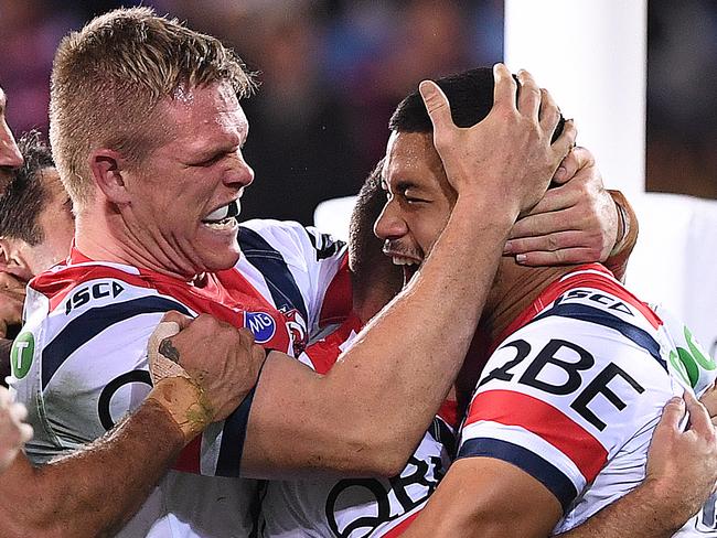 Poasa Faamausili of the Roosters (centre) reacts after scoring a try during the Round 18 NRL match between the Gold Coast Titans and the Sydney Roosters at Cbus Super Stadium on the Gold Coast, Sunday, July 15, 2018. (AAP Image/Dave Hunt) NO ARCHIVING, EDITORIAL USE ONLY