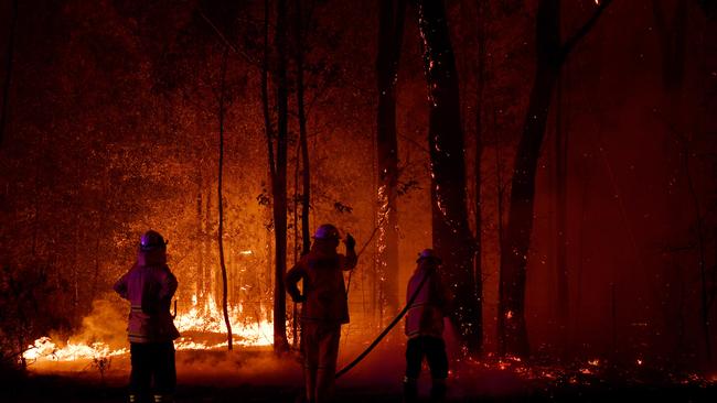 A Rural Fire Service (RFS) firefighter conducts mopping up near the town of Sussex Inlet on December 31, 2019 in Sydney, Australia. Photo: Sam Mooy/Getty Images