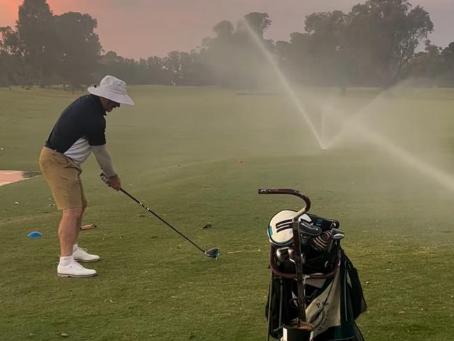 Daniel Harford teeing off as the sprinklers go on during the 'Longest Day' charity golf event. Picture: Supplied