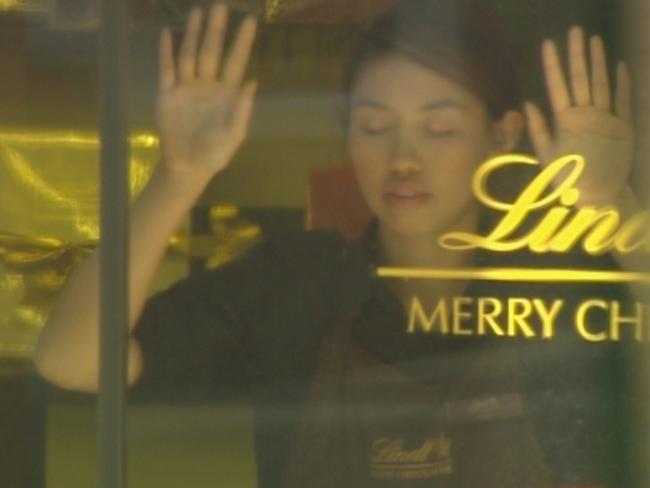 Lindt cafe hostage being forced to stand in a window during the siege. Picture: Seven News