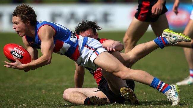 Central's Brendan Dew handballs under pressure against West Adelaide. Picture: Dean Martin