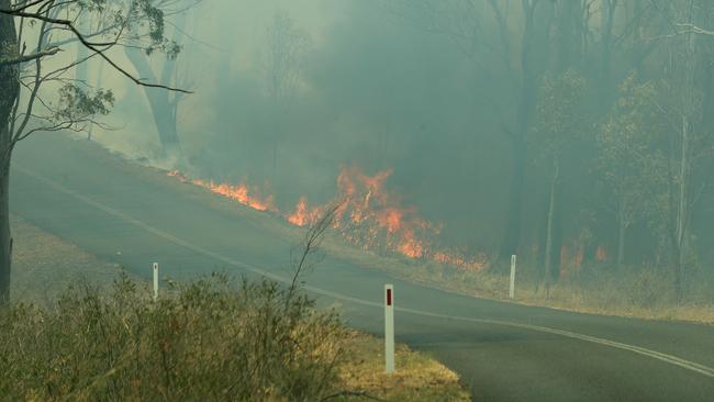 Bushfire crossing Mount Jockey Road in Ravensbourne Picture: News Corp