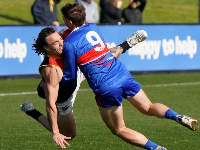 Dingley’s Josh Ferguson is wrapped up by Brad Dolan of St Paul’s McKinnon. Picture: Valeriu Campan