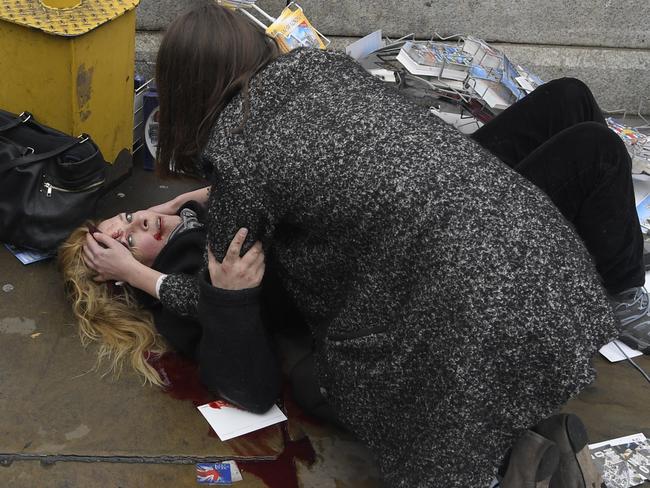 Melissa Cochran lies injured after she and her husband were hit by the attacker’s car, killing Mr Cochrane. Picture: Toby Melville/Reuters