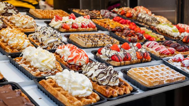 A few doors further up the street, the scene is repeated, this time over a display of waffles dripping with cream, chocolate and strawberries. Picture: iStock.