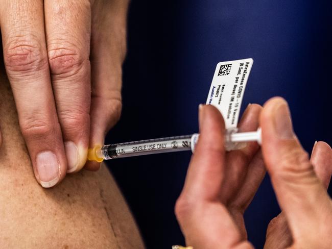 MELBOURNE, AUSTRALIA - MARCH 17: A nurse administers the AstraZeneca COVID-19 vaccine to a patient at the Austin Hospital on March 17, 2021 in Melbourne, Australia.  An online system has opened for phase 1B of the Australian COVID-19 vaccination program which includes people over aged 70, frontline workers, and individuals with certain medical conditions. Over 1000 general practitioners are participating in the vaccination program. (Photo by Asanka Ratnayake/Getty Images)