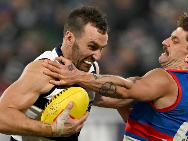 Jonathon Ceglar tries to fend off Tom Liberatore. Picture: Morgan Hancock/AFL Photos/via Getty Images