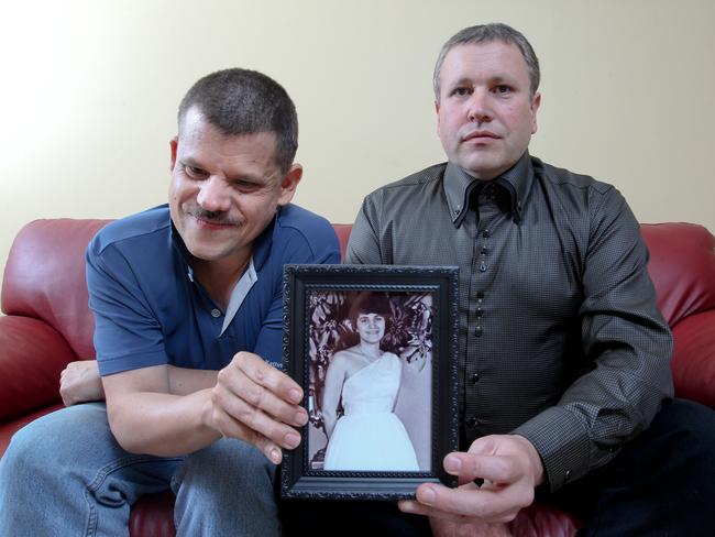 Adam James (left) and his brother Mark James with a picture of their murdered mother Maria James. Picture: Scott Chris 