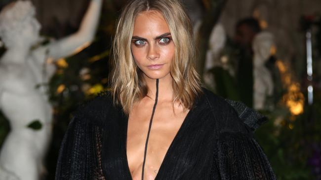 Cara Delevingne turns head with an unusual line down her chest at the 2016 London Fashion Week.